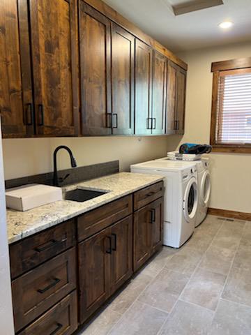 Custom laundry room with dark stained cabinetry and granite countertops