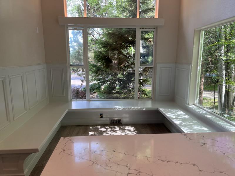 Built-in dining banquette with calacatta quartz top and panel molding